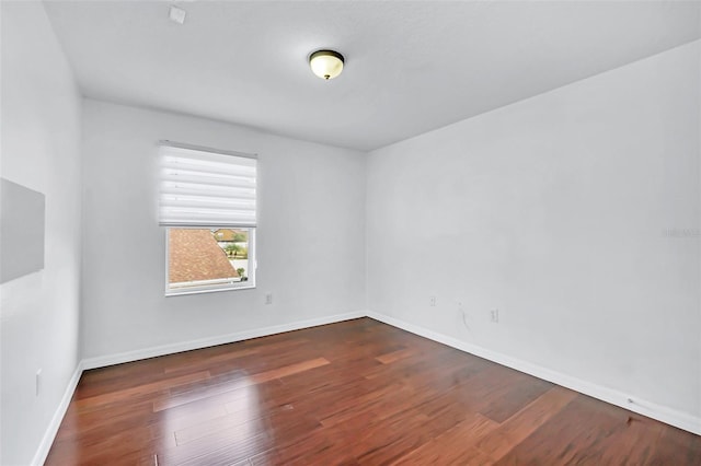 unfurnished room featuring dark wood-type flooring