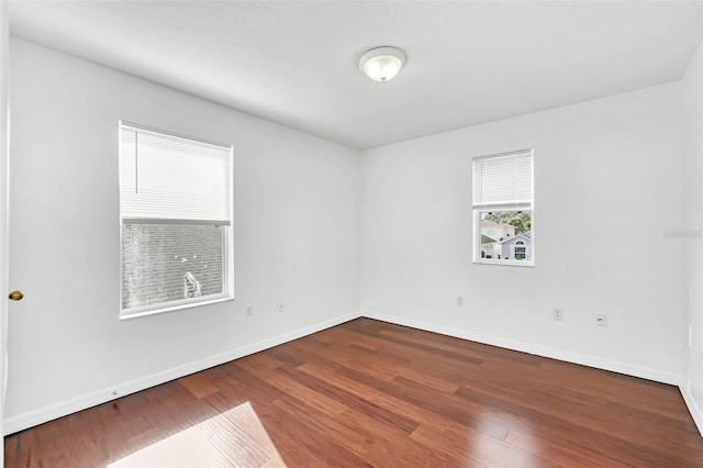 unfurnished room with hardwood / wood-style floors