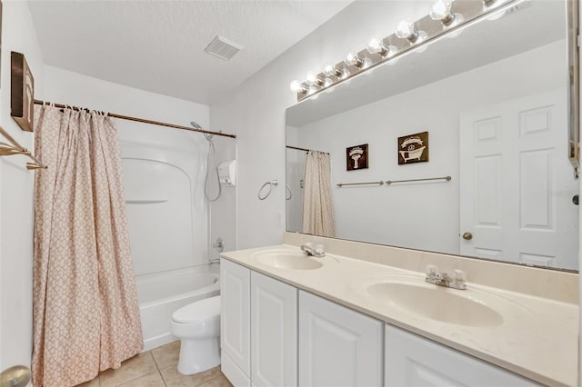 full bathroom featuring shower / bath combo, tile patterned floors, toilet, a textured ceiling, and vanity