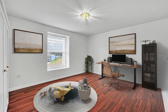 office with dark wood-type flooring and a textured ceiling