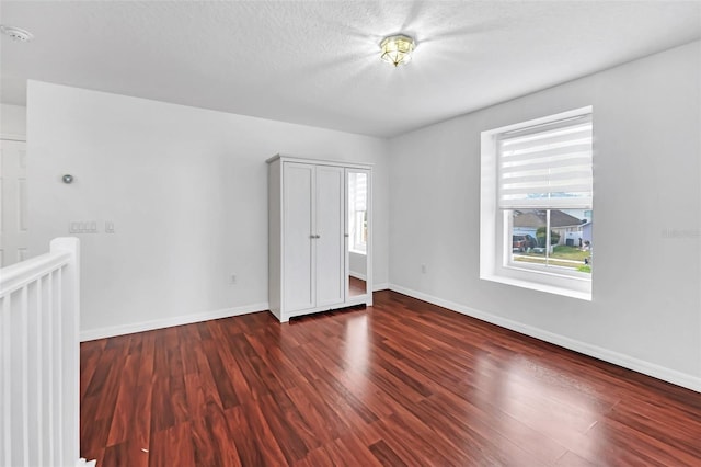 unfurnished bedroom featuring dark wood-type flooring