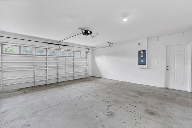 garage featuring electric panel and a garage door opener