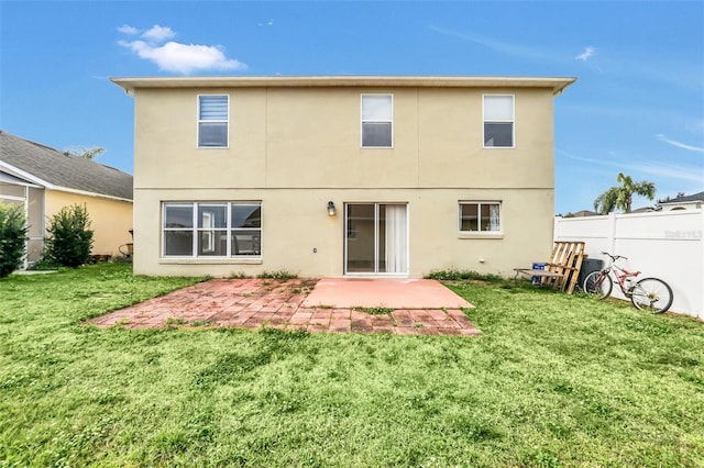 rear view of property with a patio area and a lawn