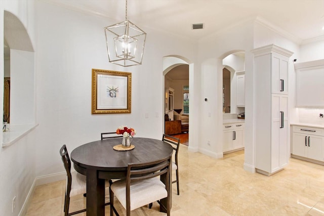 dining space featuring an inviting chandelier and ornamental molding