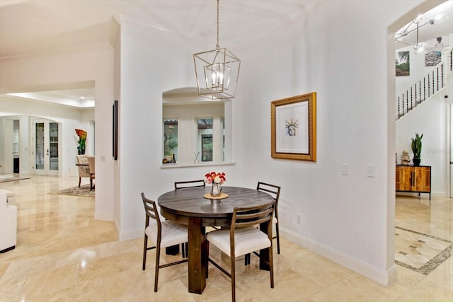 dining room with french doors, a chandelier, and crown molding