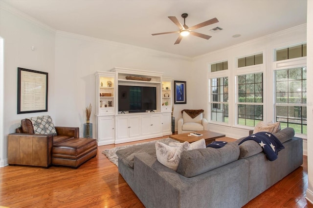 living room featuring ceiling fan, hardwood / wood-style floors, and crown molding