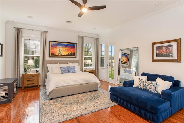 bedroom featuring ceiling fan, ornamental molding, and access to outside