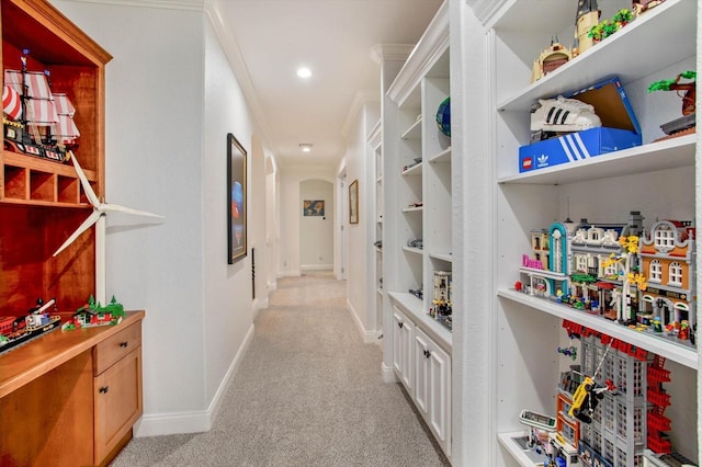 hallway with light carpet and ornamental molding