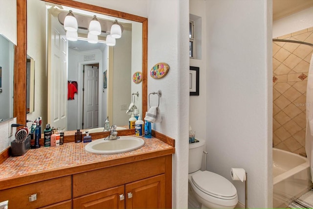 full bathroom featuring toilet, vanity, crown molding, and tiled shower / bath combo