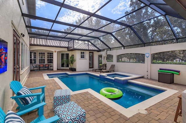 view of swimming pool featuring an in ground hot tub, a lanai, and a patio