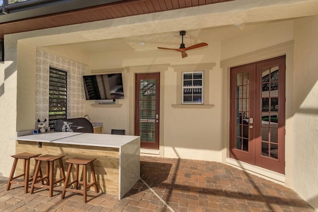 view of patio featuring exterior bar, ceiling fan, and french doors