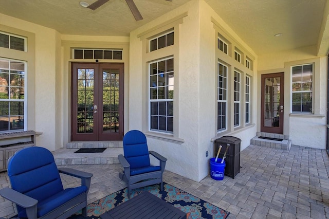 entrance to property featuring ceiling fan and french doors