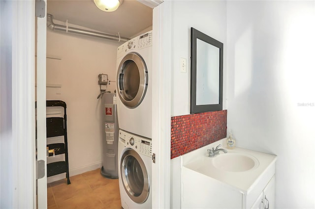 laundry area with water heater, stacked washer and dryer, and sink