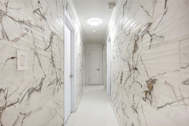 hallway featuring tile patterned floors and ornamental molding