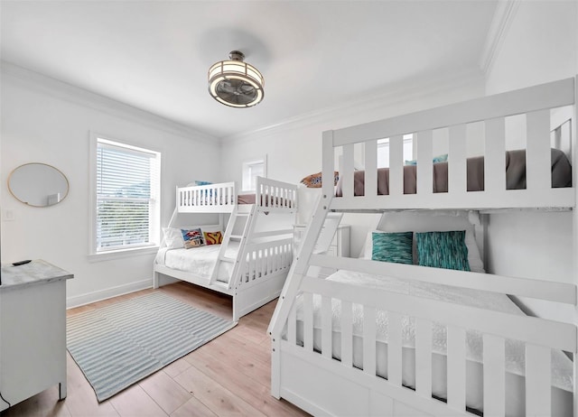 bedroom with light hardwood / wood-style floors and ornamental molding