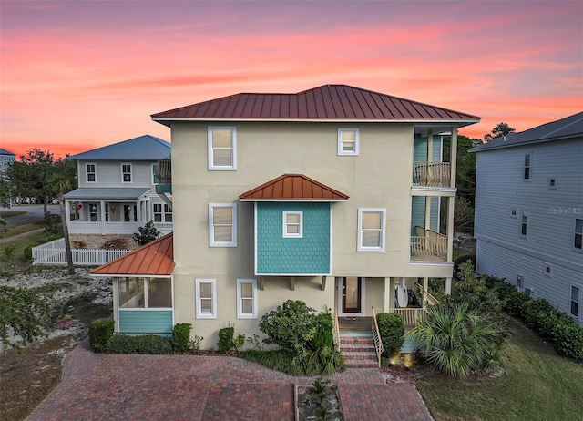 view of front of property featuring a balcony and covered porch