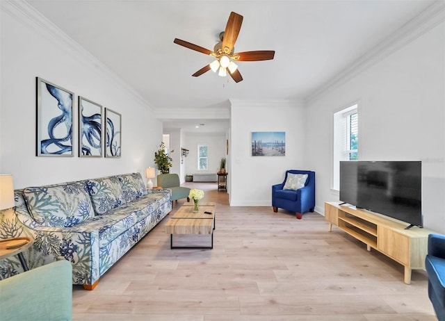 living room with light wood-type flooring, ceiling fan, and crown molding