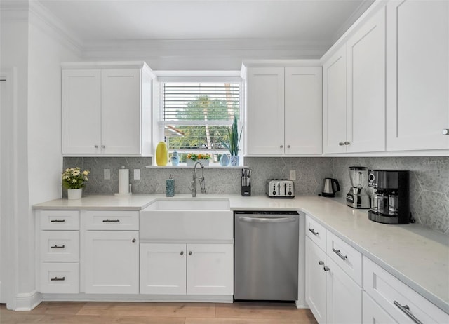 kitchen featuring sink, white cabinetry, backsplash, and dishwasher