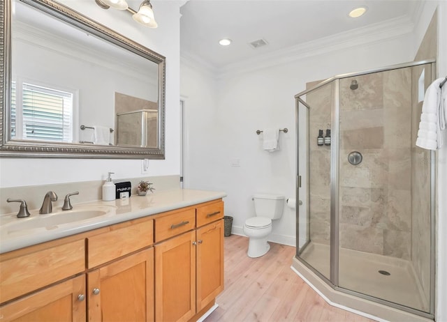 bathroom with crown molding, wood-type flooring, an enclosed shower, and vanity