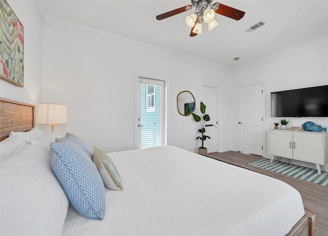 bedroom featuring ceiling fan, hardwood / wood-style flooring, and ornamental molding