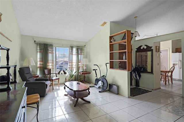 living room featuring vaulted ceiling, a textured ceiling, and light tile patterned flooring