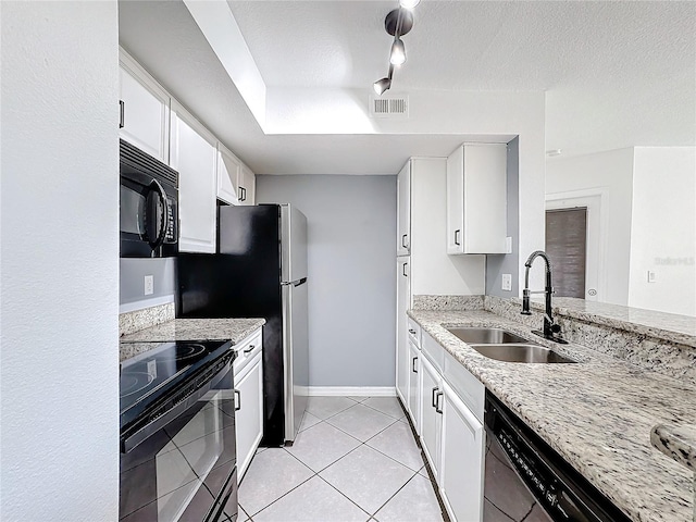 kitchen with white cabinetry, sink, light stone counters, and black appliances