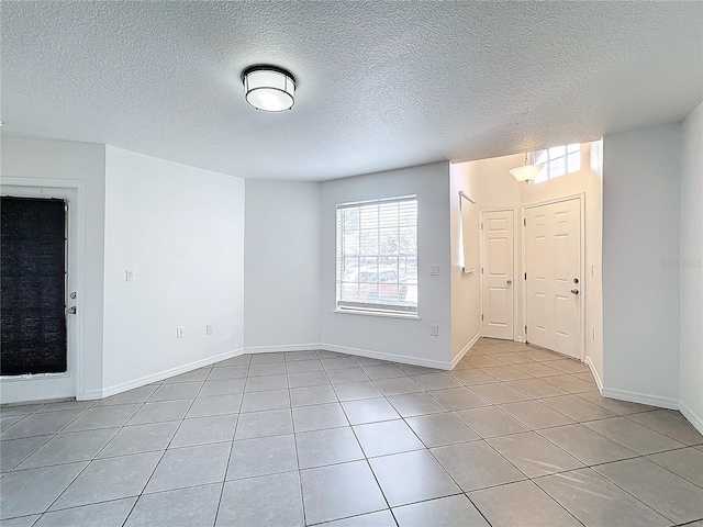 tiled entryway with a textured ceiling