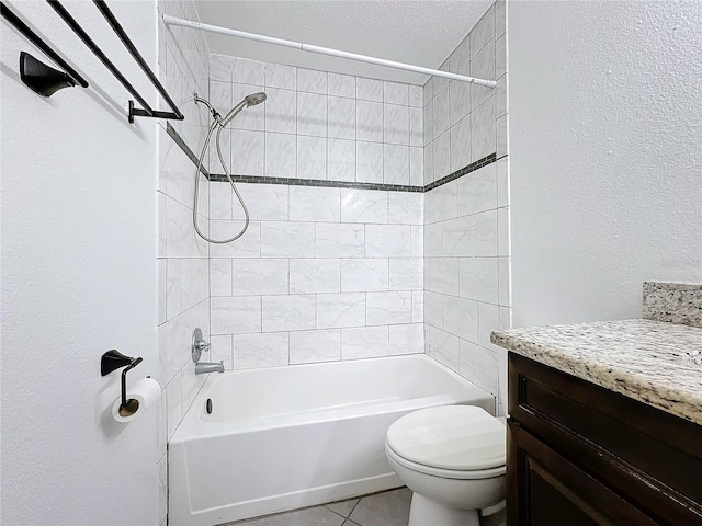 full bathroom featuring tile patterned floors, vanity, toilet, and tiled shower / bath combo