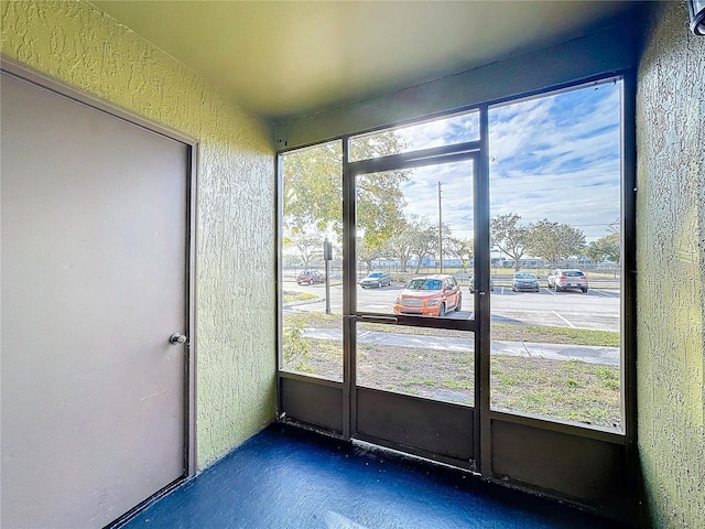 unfurnished sunroom featuring plenty of natural light