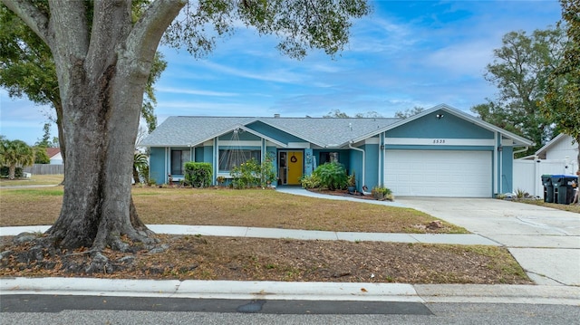 single story home with a garage and a front yard