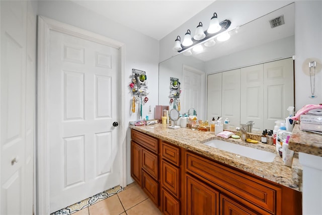 bathroom featuring tile patterned flooring and vanity