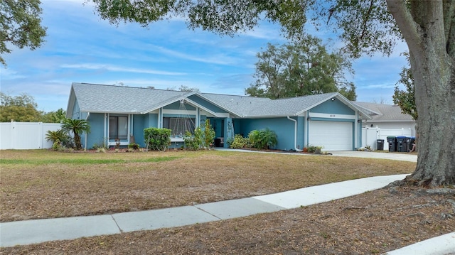 ranch-style house featuring a garage and a front yard