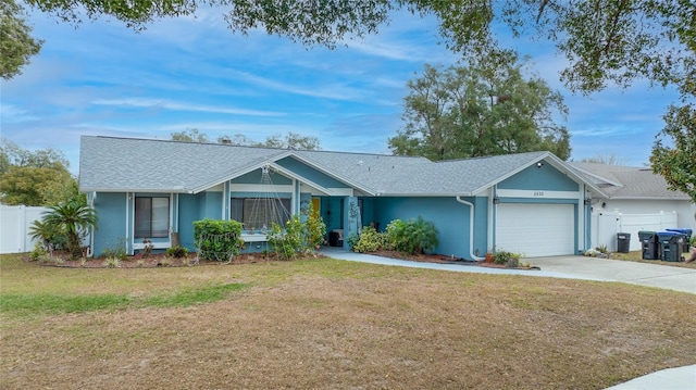 ranch-style home featuring a garage and a front lawn