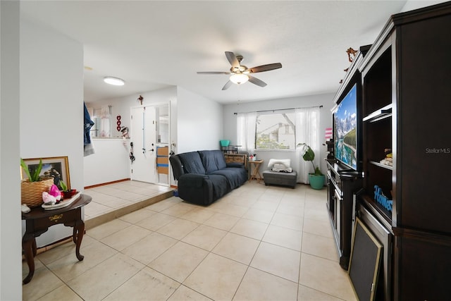 living room featuring light tile patterned floors and ceiling fan