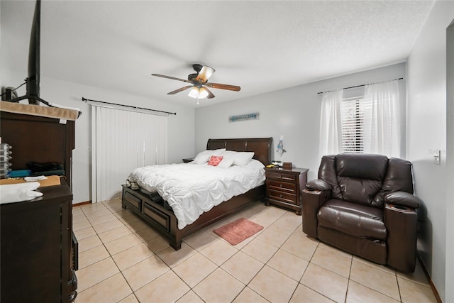 tiled bedroom featuring ceiling fan and a textured ceiling