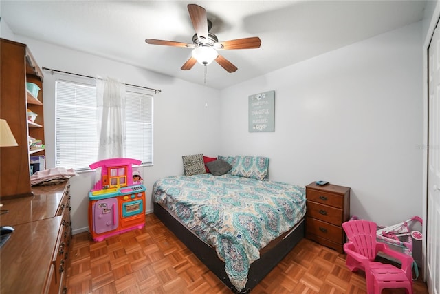 bedroom with parquet floors and ceiling fan