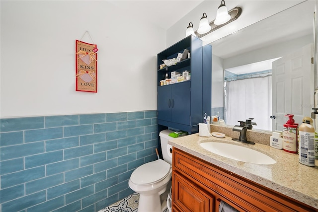 bathroom featuring tile walls, vanity, and toilet