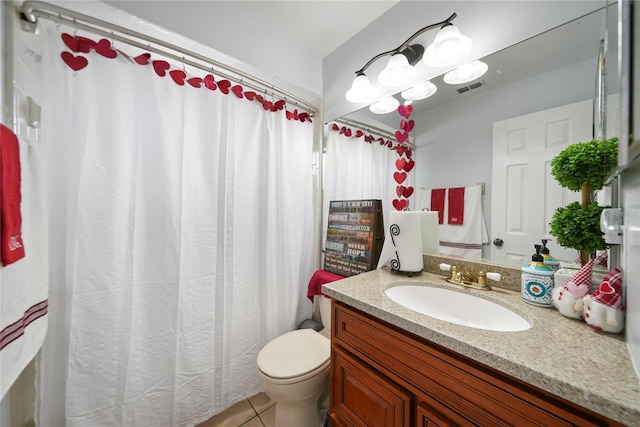 bathroom with tile patterned floors, vanity, and toilet