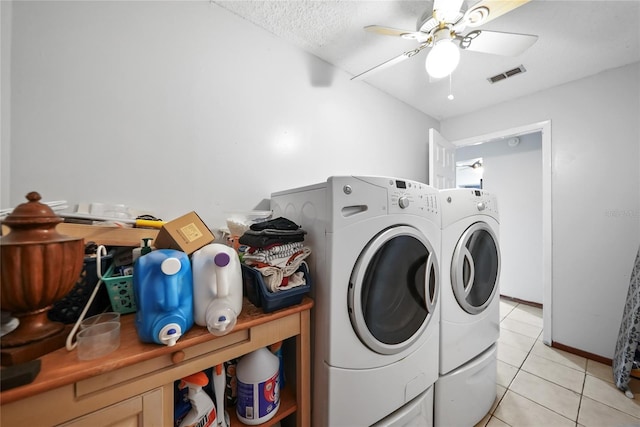 washroom with ceiling fan, separate washer and dryer, a textured ceiling, and light tile patterned floors