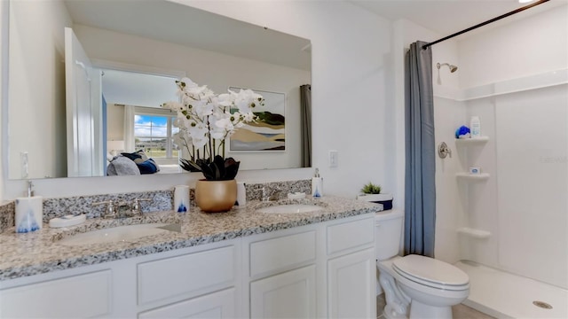 bathroom featuring toilet, walk in shower, and vanity