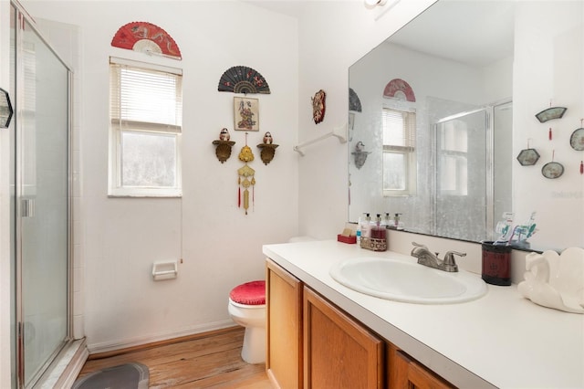 bathroom featuring a shower with door, a wealth of natural light, and toilet