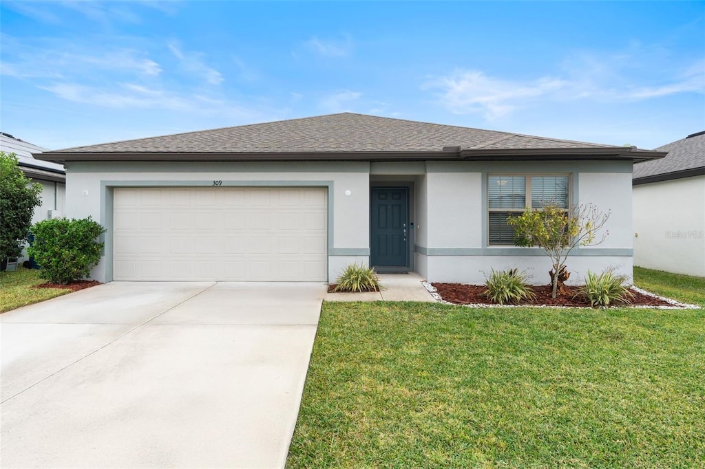 view of front of home featuring a garage and a front lawn