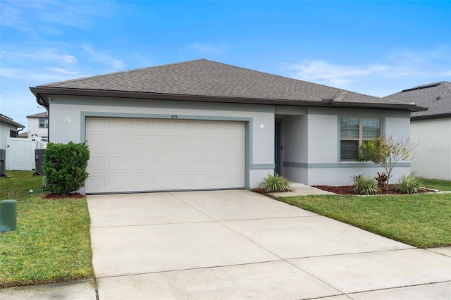 view of front of home with a garage and a front lawn