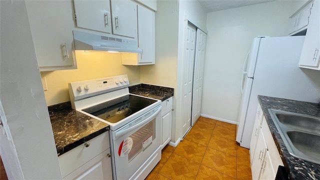 kitchen with sink, light tile patterned flooring, white appliances, and white cabinetry