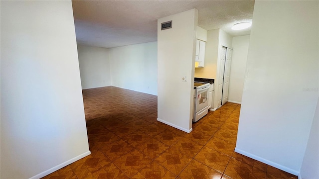 hall with a textured ceiling