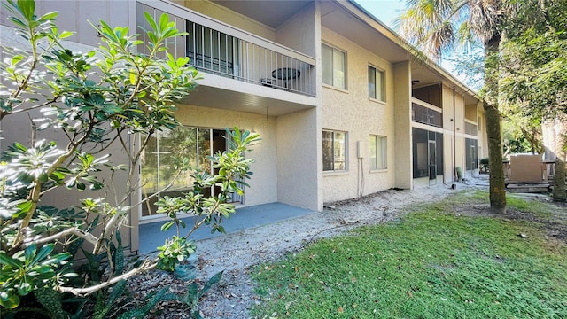 view of side of home featuring a balcony