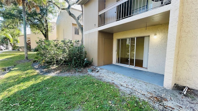 doorway to property with a lawn