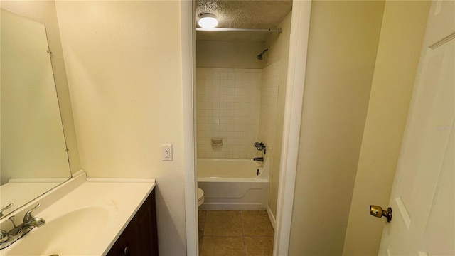 full bathroom featuring toilet, a textured ceiling, tile patterned flooring, vanity, and tiled shower / bath