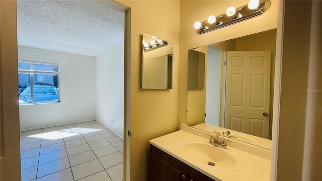 bathroom featuring a textured ceiling, vanity, and tile patterned flooring