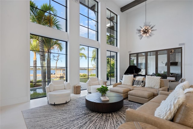 living room featuring an inviting chandelier and a towering ceiling